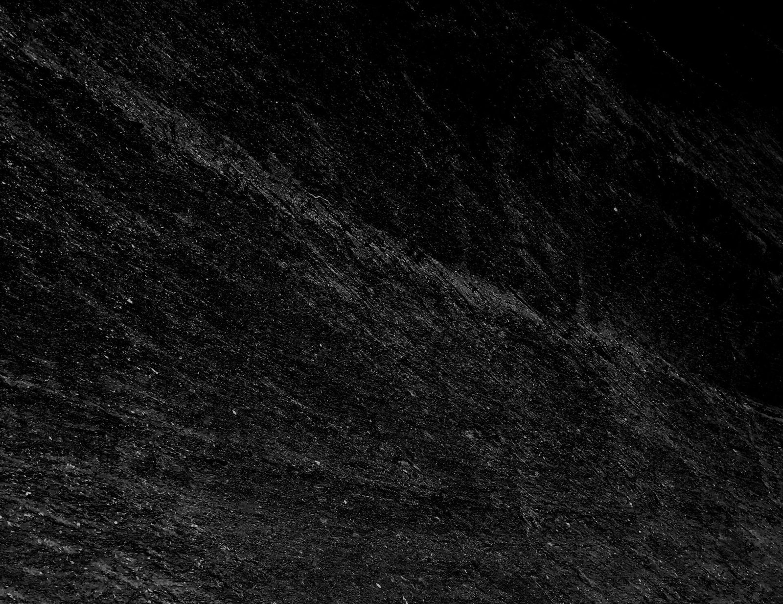 A vertical grey scale shot of a black surface